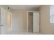 Bedroom with tile floor, closet, and doorway leading to another room at 451 Rogers St, Orlando, FL 32811