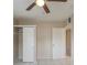 This bedroom features tile floor, ceiling fan, and a closet at 451 Rogers St, Orlando, FL 32811
