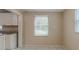 Bright dining area featuring tile flooring, a window with blinds, and a view into the kitchen at 451 Rogers St, Orlando, FL 32811