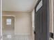 A foyer featuring tile floors, neutral walls, and natural light streaming through the decorative front door at 451 Rogers St, Orlando, FL 32811