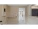 Hallway includes tile floors, neutral walls, access to utilities and connects to other rooms at 451 Rogers St, Orlando, FL 32811