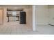 Open-concept kitchen and living space with stainless steel appliances and white cabinets at 451 Rogers St, Orlando, FL 32811