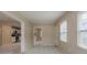 Open living room with tile flooring, natural light from the windows, and flow into the kitchen at 451 Rogers St, Orlando, FL 32811