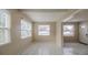 Bright living room with ample natural light, neutral walls, and tile flooring throughout the space at 451 Rogers St, Orlando, FL 32811