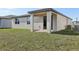 Spacious backyard showing the covered patio and exterior architecture of the home at 4543 Sidesaddle Trl, St Cloud, FL 34772