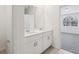 Bright bathroom featuring double sinks, white cabinets, and a view into an adjacent bedroom at 4543 Sidesaddle Trl, St Cloud, FL 34772