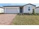 Charming single-story home featuring a brick driveway, attached garage and freshly landscaped front yard at 4543 Sidesaddle Trl, St Cloud, FL 34772