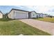 View of a single-story home featuring an attached garage, brick driveway, and manicured front yard at 4543 Sidesaddle Trl, St Cloud, FL 34772