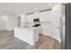 This modern kitchen showcases a center island, stainless steel appliances, white cabinets, and a sleek design at 4543 Sidesaddle Trl, St Cloud, FL 34772