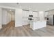 Well-lit kitchen features white cabinetry, stainless steel appliances, subway tile backsplash, and a center island with quartz countertop at 4543 Sidesaddle Trl, St Cloud, FL 34772