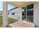 Back patio with brick flooring and sliding glass doors leading inside, overlooking the grassy backyard at 4543 Sidesaddle Trl, St Cloud, FL 34772