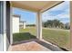 Covered patio with brick flooring, offering views of the green lawn and neighborhood street at 4543 Sidesaddle Trl, St Cloud, FL 34772