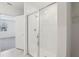 Modern bathroom featuring a glass-enclosed shower with white tiling and a view to an adjacent bedroom at 4543 Sidesaddle Trl, St Cloud, FL 34772
