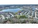 Property aerial view set in a lakeside community, surrounded by trees, homes, and tranquil waterways at 4608 Egg Harbor Dr, Kissimmee, FL 34746