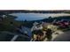 Beautiful aerial view of a home by a lake with manicured lawns and vibrant community during a stunning sunset at 4608 Egg Harbor Dr, Kissimmee, FL 34746