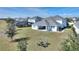 Spacious backyard with a fire pit seating area, lush green lawn, and an enclosed pool in a neighboring property at 4608 Egg Harbor Dr, Kissimmee, FL 34746