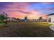Scenic backyard view with lush lawn, water views, and exterior lighting, perfect for outdoor entertaining at 4608 Egg Harbor Dr, Kissimmee, FL 34746