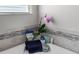 Close-up of bathroom detailing including a corner tub with stylish decor, a plant, and a small window at 4608 Egg Harbor Dr, Kissimmee, FL 34746