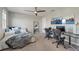 Bedroom featuring a bed, two desks, and a large window at 4608 Egg Harbor Dr, Kissimmee, FL 34746
