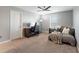 Cozy bedroom featuring neutral walls, comfortable bed, ceiling fan, and dedicated workspace with desk and gaming chair at 4608 Egg Harbor Dr, Kissimmee, FL 34746