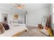 Spacious bedroom featuring carpet, a bed with designer pillows, modern furniture, and soft natural light at 4608 Egg Harbor Dr, Kissimmee, FL 34746