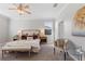 Cozy bedroom with plush bedding, side tables, and bench seating, illuminated by stylish lamps and natural light at 4608 Egg Harbor Dr, Kissimmee, FL 34746