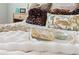 Detail of a plush bed with decorative pillows, a luxurious throw, and a decorative serving tray at 4608 Egg Harbor Dr, Kissimmee, FL 34746