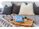 Close-up shot of a neatly arranged bed with plush pillows, a decorative tray, and a book resting on the soft blanket at 4608 Egg Harbor Dr, Kissimmee, FL 34746