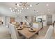 Open-concept dining area featuring a modern chandelier, wood table with seating, and a view of the gourmet kitchen at 4608 Egg Harbor Dr, Kissimmee, FL 34746