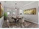 Elegant dining room with seating for eight, stylish rug, and modern art, perfect for entertaining and Gathering meals at 4608 Egg Harbor Dr, Kissimmee, FL 34746