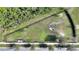 Aerial view of fenced community dog park featuring green space, seating, waste station and convenient pet waste disposal at 4608 Egg Harbor Dr, Kissimmee, FL 34746
