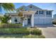 Charming two-story home with a welcoming front porch, manicured garden, and a three-car garage enhancing curb appeal at 4608 Egg Harbor Dr, Kissimmee, FL 34746