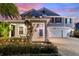 Inviting two-story home with a covered porch and manicured front yard at 4608 Egg Harbor Dr, Kissimmee, FL 34746