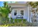 Inviting front porch adorned with lush greenery, decorative pillows, and charming accents for relaxed outdoor living at 4608 Egg Harbor Dr, Kissimmee, FL 34746