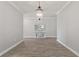 Inviting hallway featuring stylish wood-look tile flooring, elegant light fixture, and console table, perfect for entry at 4608 Egg Harbor Dr, Kissimmee, FL 34746