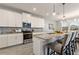 Modern kitchen features granite counters, stainless steel appliances, gray tile backsplash and hardwood floors at 4608 Egg Harbor Dr, Kissimmee, FL 34746