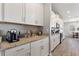 Stylish kitchen boasts granite countertops, stainless steel appliances, gray tile backsplash and wood look flooring at 4608 Egg Harbor Dr, Kissimmee, FL 34746