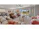 Open-concept living room featuring modern furniture, a decorative rug, sliding glass doors to the backyard, and a ceiling fan at 4608 Egg Harbor Dr, Kissimmee, FL 34746