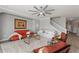Cozy living room features comfortable furniture, decorative artwork, a modern ceiling fan, and plenty of natural light at 4608 Egg Harbor Dr, Kissimmee, FL 34746