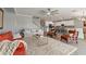 Open living room with plush seating, a modern ceiling fan, adjacent dining area and a view of the kitchen at 4608 Egg Harbor Dr, Kissimmee, FL 34746