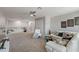 Spacious carpeted living room featuring white couches, a glass table, and modern decor at 4608 Egg Harbor Dr, Kissimmee, FL 34746