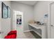 Bright mud room featuring granite counters, built-in storage, and a view into the walk-in closet at 4608 Egg Harbor Dr, Kissimmee, FL 34746