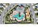 Aerial view of community pool, amenity center, and playground surrounded by lush landscaping and neighborhood streets at 4608 Egg Harbor Dr, Kissimmee, FL 34746