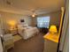 Cozy bedroom features a ceiling fan, natural light and neutral wall color at 482 Hildalgo Dr, The Villages, FL 32159