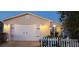 Charming single-Gathering home features a two-car garage, complemented by a white picket fence and fresh landscaping at 482 Hildalgo Dr, The Villages, FL 32159