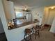 Galley kitchen with a breakfast bar, updated appliances, and new flooring at 482 Hildalgo Dr, The Villages, FL 32159