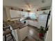 Bright kitchen with white cabinets, breakfast bar, and modern appliances for easy meal preparation at 482 Hildalgo Dr, The Villages, FL 32159