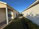 Side yard featuring a walkway, grass, and landscaping at 482 Hildalgo Dr, The Villages, FL 32159