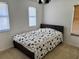Well-lit bedroom featuring a bed with patterned bedding and ample natural light from the window at 525 Aster Dr, Davenport, FL 33897
