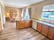 Charming kitchen featuring wood cabinets and flooring, updated appliances, and natural light at 525 Aster Dr, Davenport, FL 33897
